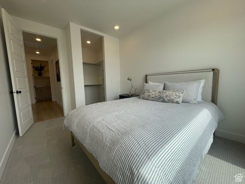 Carpeted bedroom featuring recessed lighting and baseboards