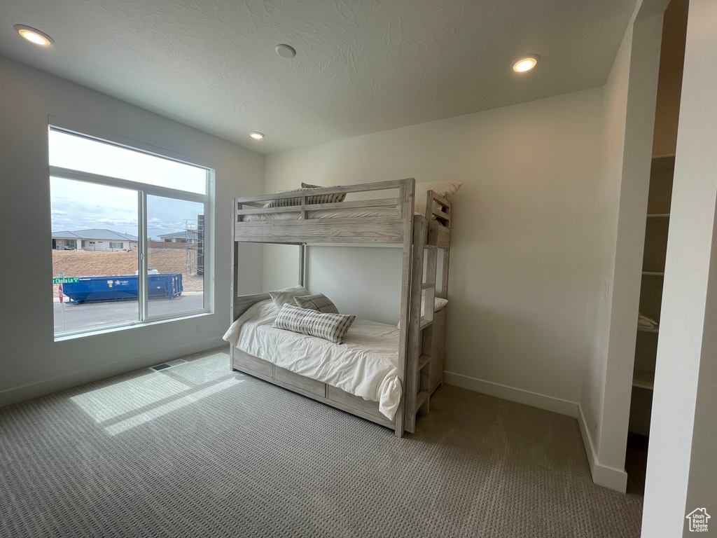 Bedroom featuring carpet floors, baseboards, and recessed lighting