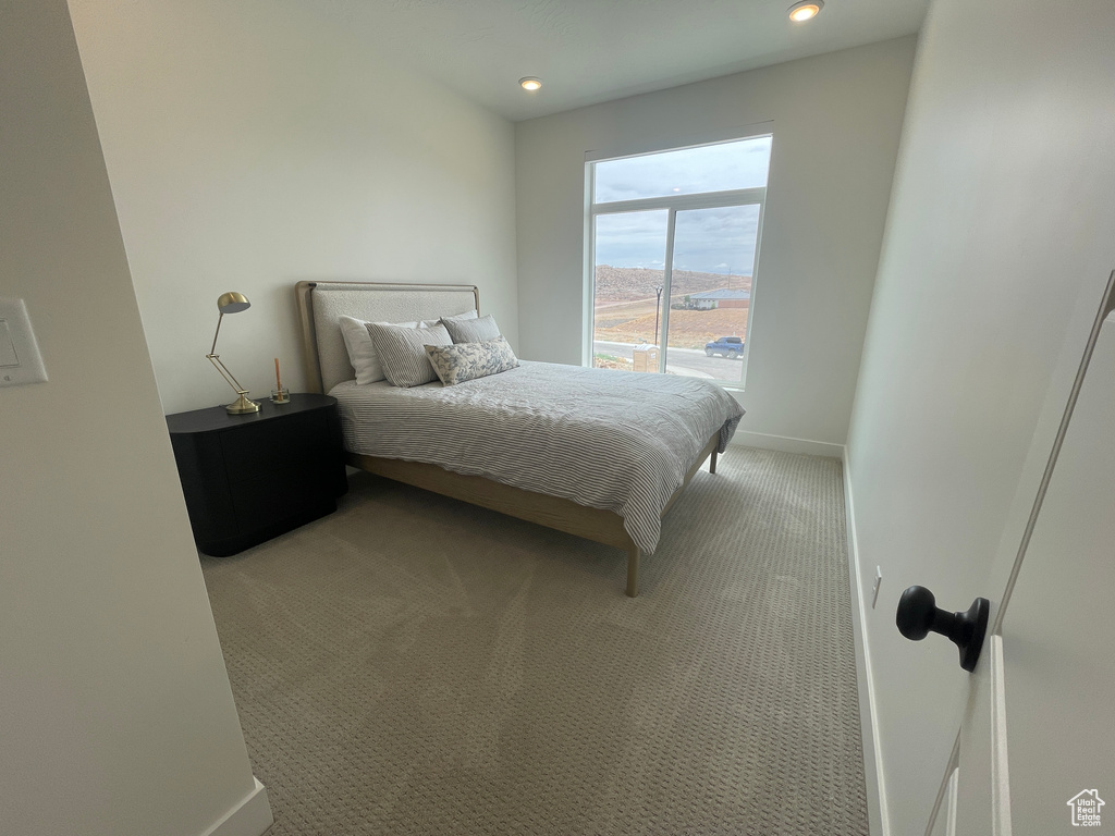 Bedroom featuring light colored carpet, baseboards, and recessed lighting