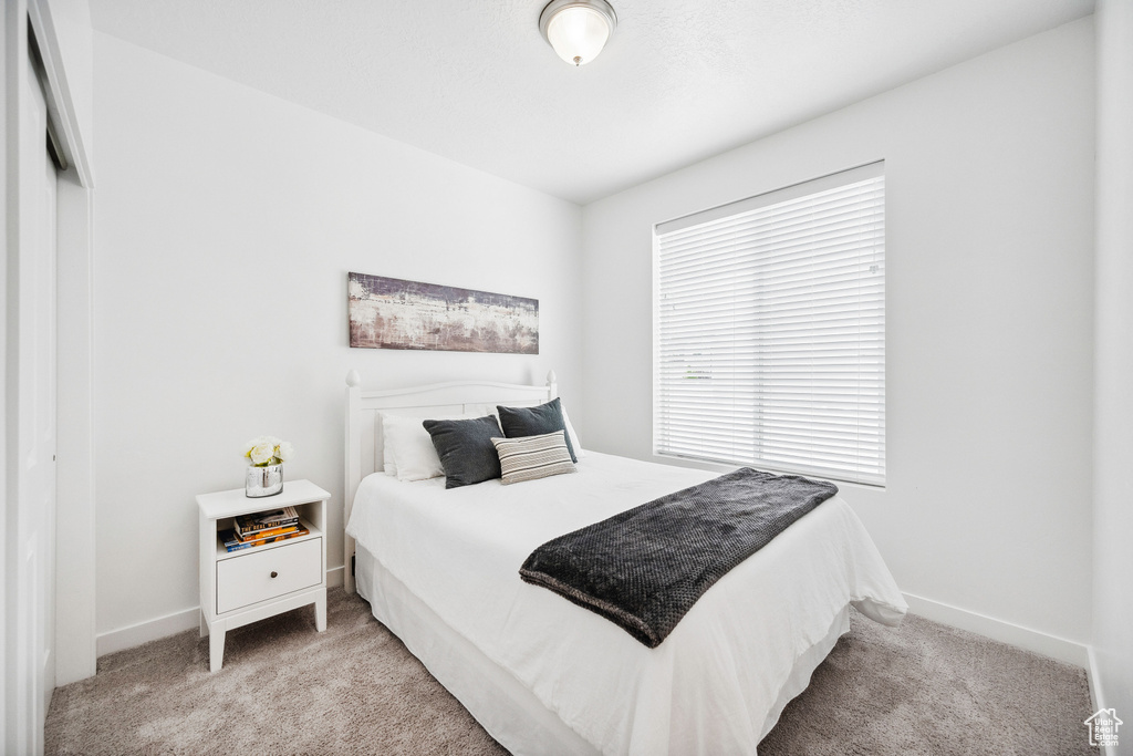 Carpeted bedroom with baseboards