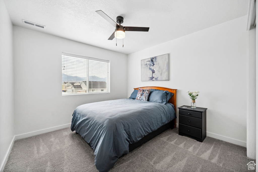 Bedroom with carpet flooring, baseboards, and ceiling fan