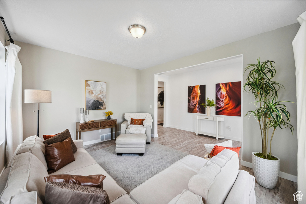 Living area with wood finished floors and baseboards
