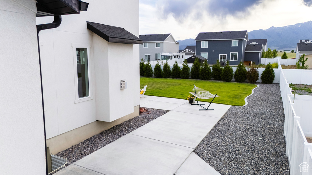 View of patio / terrace with a residential view and a mountain view