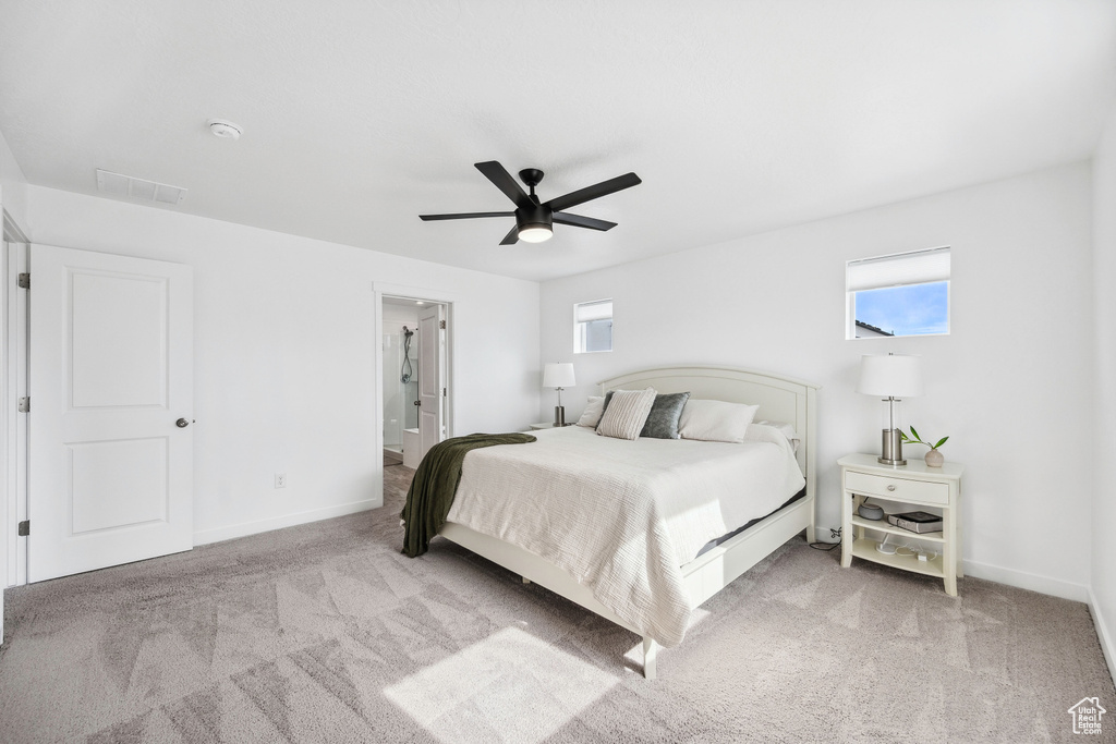 Bedroom with carpet flooring, baseboards, and multiple windows