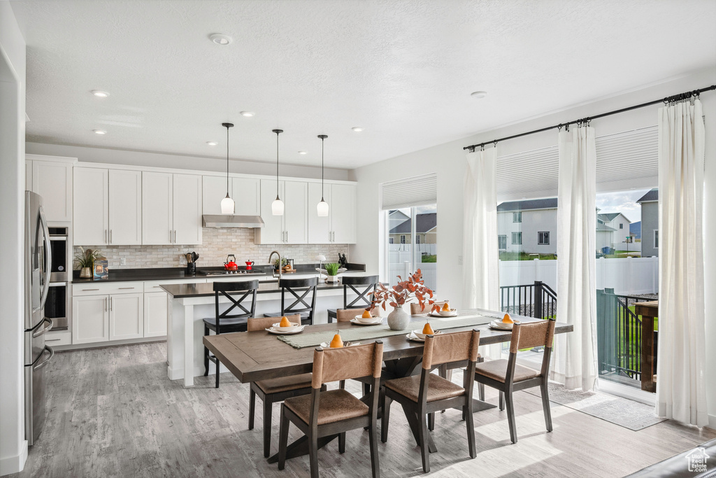 Dining area featuring light wood-type flooring and recessed lighting