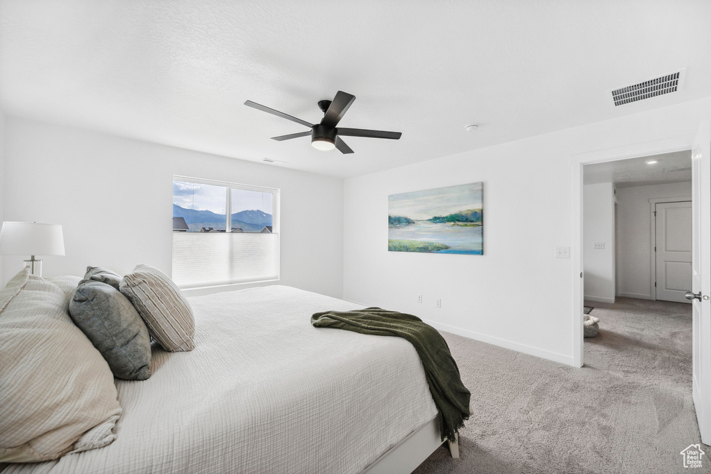 Carpeted bedroom with baseboards and ceiling fan