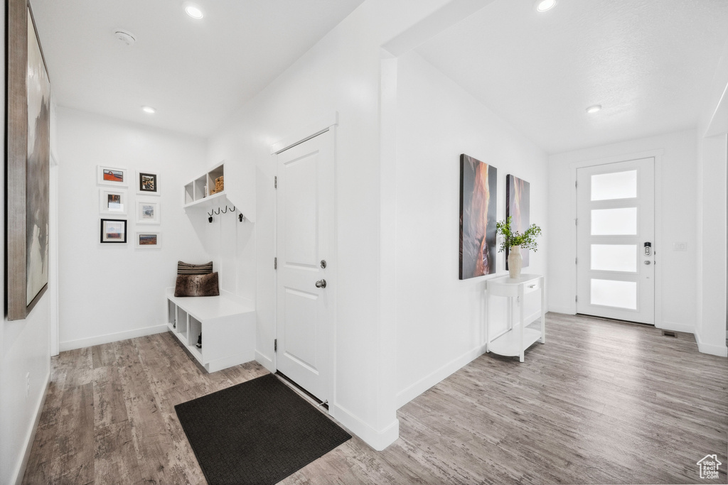 Mudroom with light wood-style floors, recessed lighting, and baseboards