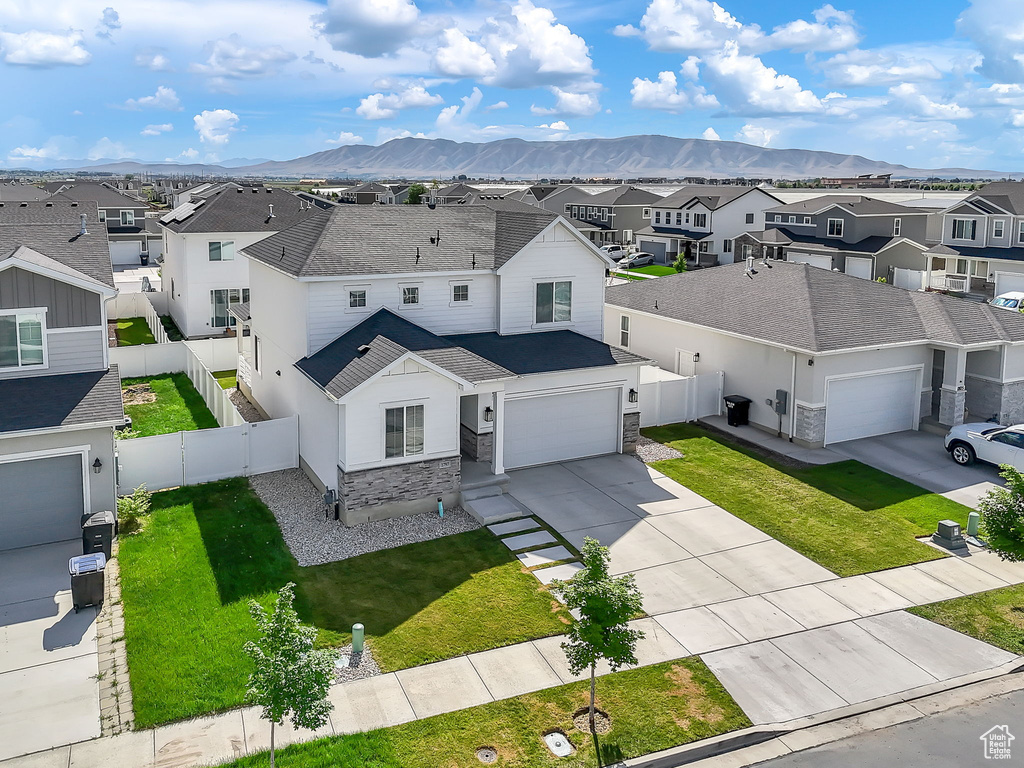 Aerial perspective of suburban area featuring a mountain backdrop