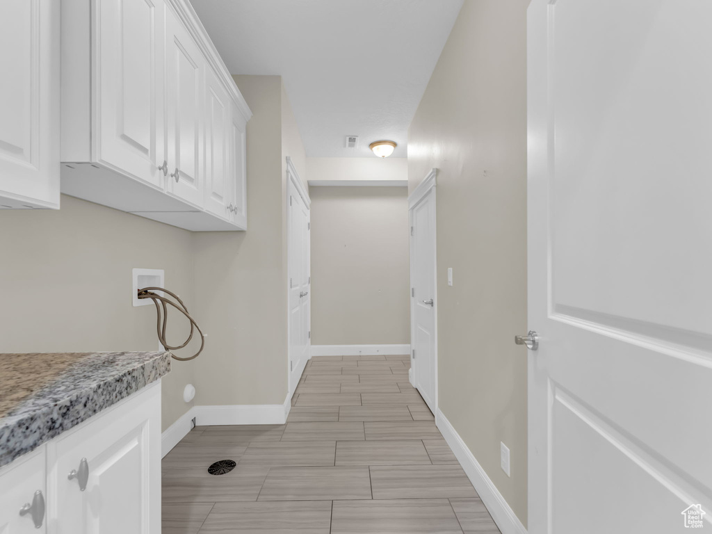 Laundry area with washer hookup and baseboards