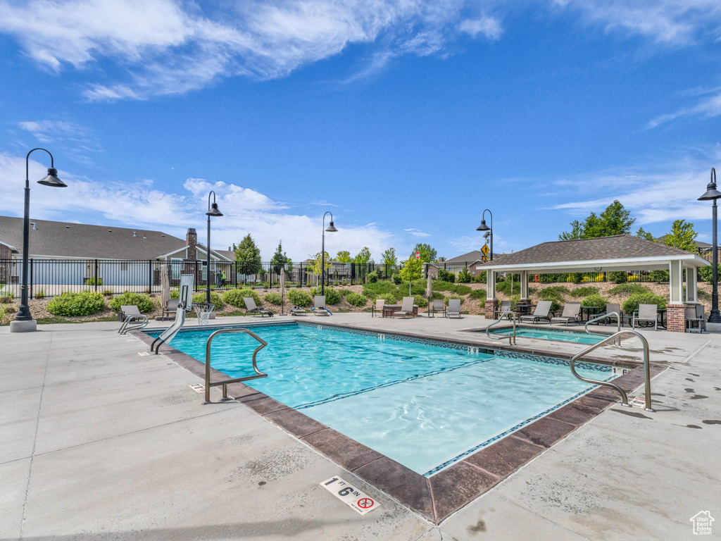 Community pool with a patio and a gazebo