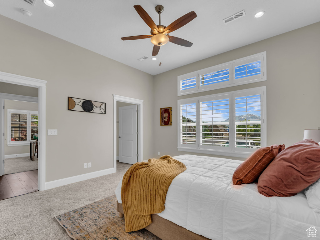 Carpeted bedroom featuring recessed lighting, baseboards, and a ceiling fan