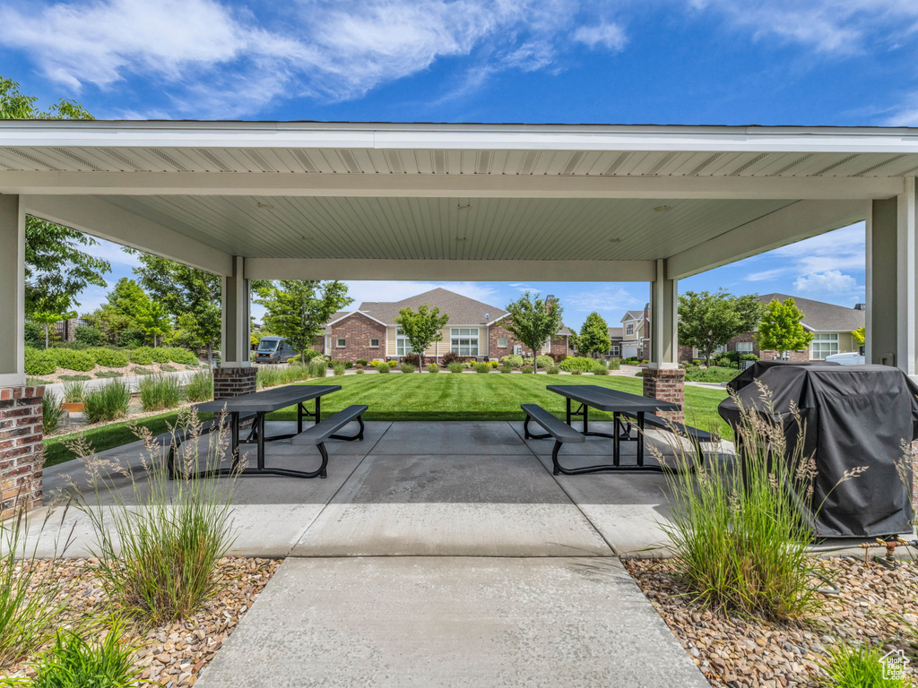 Surrounding community featuring a lawn, a patio, and outdoor dining space