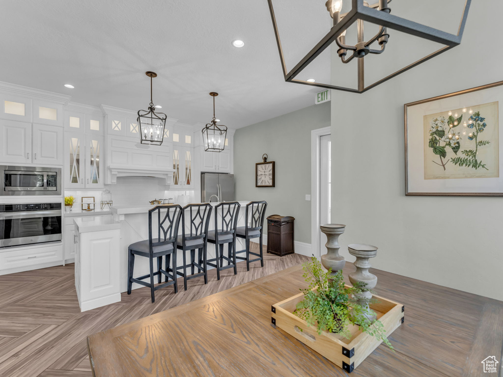 Dining area with a chandelier and recessed lighting