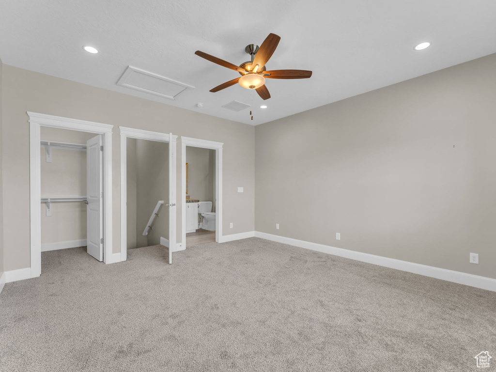 Unfurnished bedroom with light colored carpet, recessed lighting, attic access, baseboards, and ceiling fan