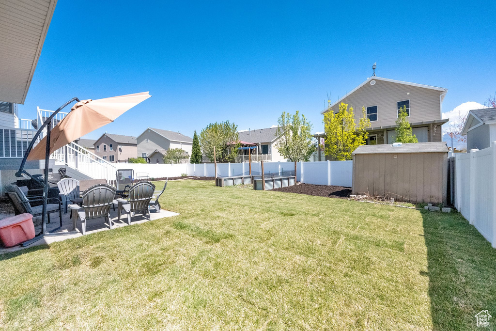 View of yard featuring a patio and a residential view