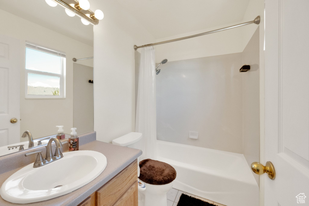 Bathroom with toilet, vanity, shower / bath combo, and tile patterned flooring