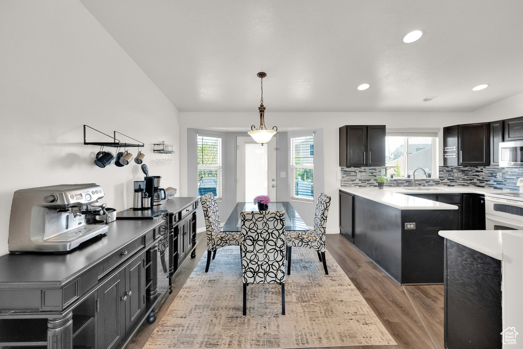 Dining area with light wood-style floors and recessed lighting