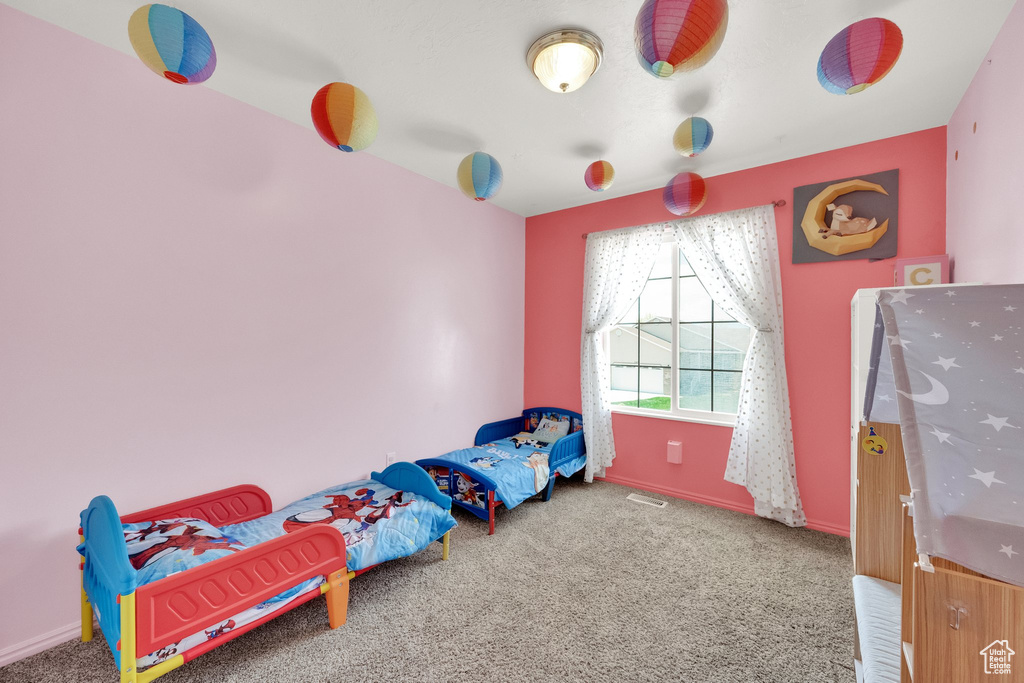 Unfurnished bedroom featuring carpet floors and baseboards