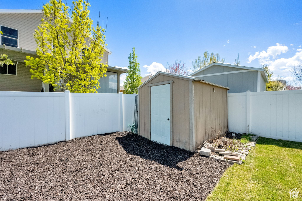 View of shed with a fenced backyard