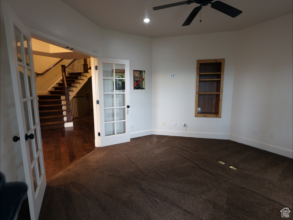 Carpeted spare room with french doors, a ceiling fan, stairway, baseboards, and recessed lighting