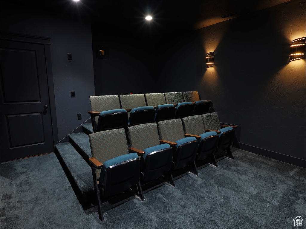Carpeted home theater room with recessed lighting