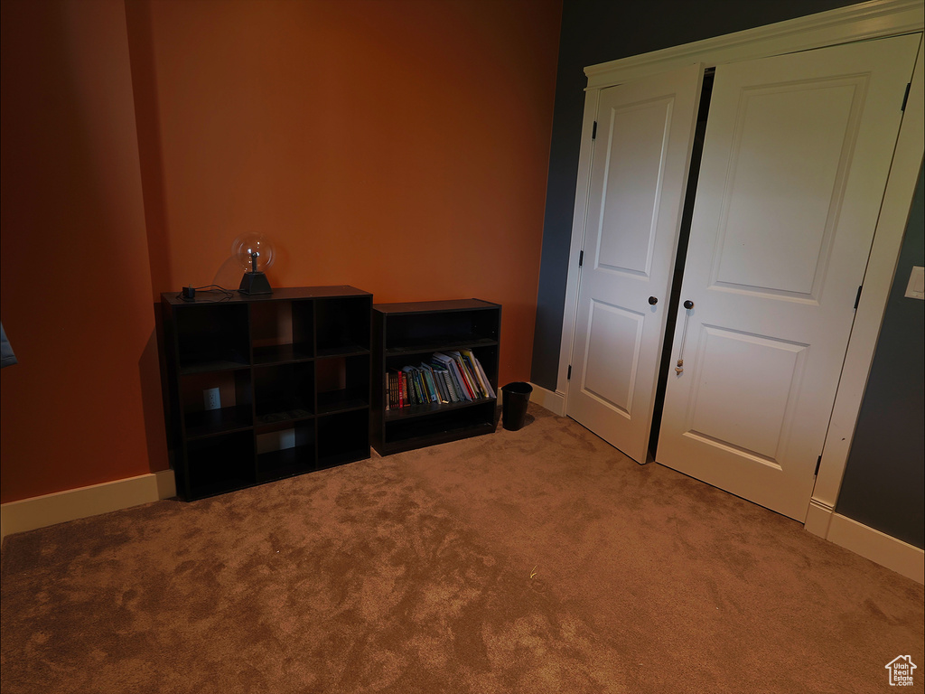 Living area featuring carpet and baseboards