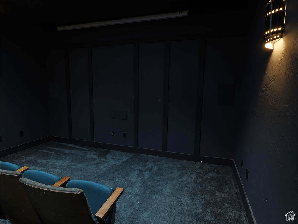 Below grade area featuring carpet flooring, a decorative wall, and baseboards