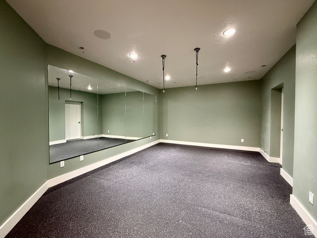 Empty room with recessed lighting and light aggregate flooring