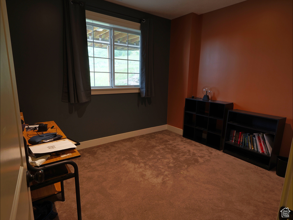 Living area featuring carpet floors and baseboards