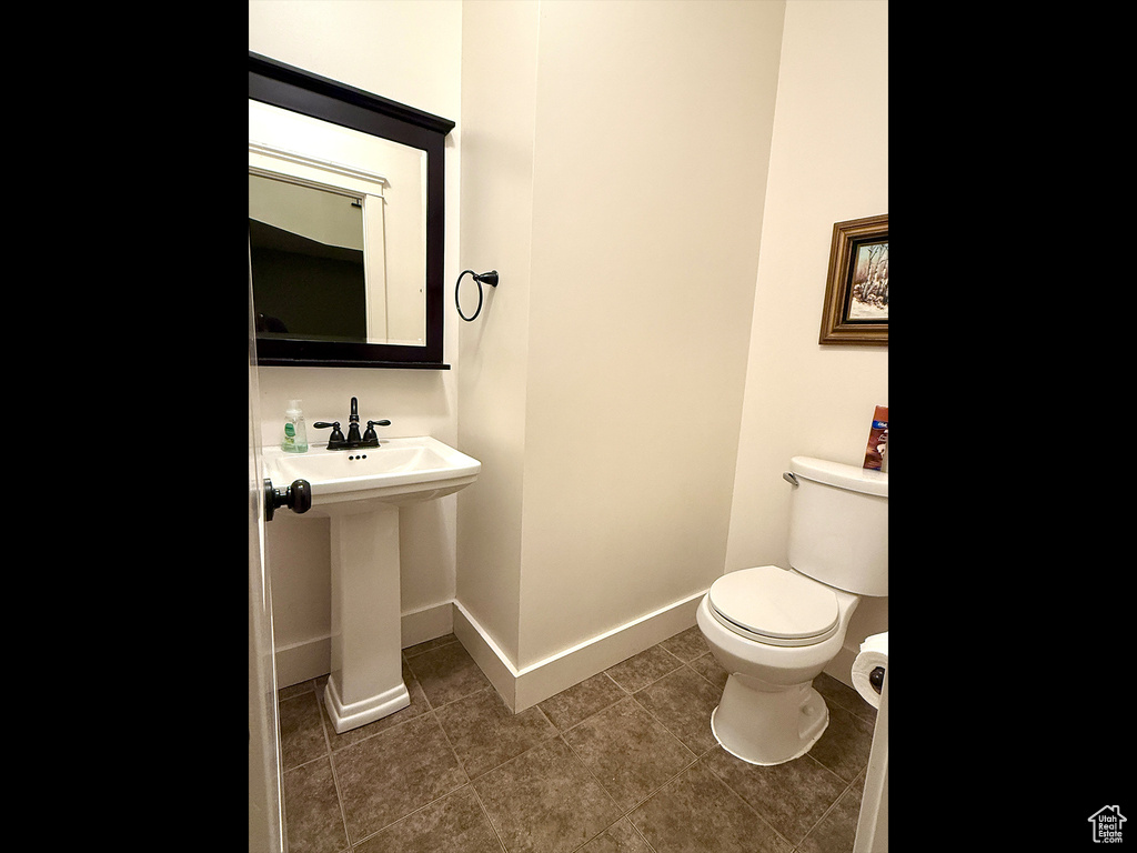 Bathroom featuring toilet and tile patterned flooring