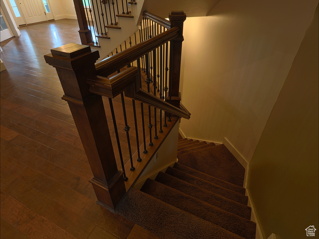 Stairs with baseboards and wood-type flooring