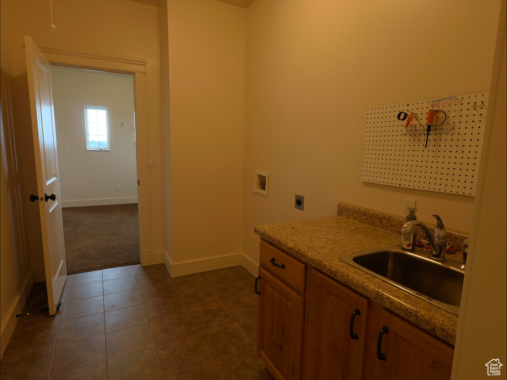 Laundry area with hookup for an electric dryer, baseboards, washer hookup, dark tile patterned floors, and dark carpet