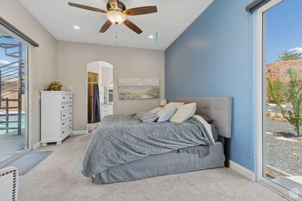 Bedroom featuring light colored carpet, access to exterior, arched walkways, recessed lighting, and baseboards