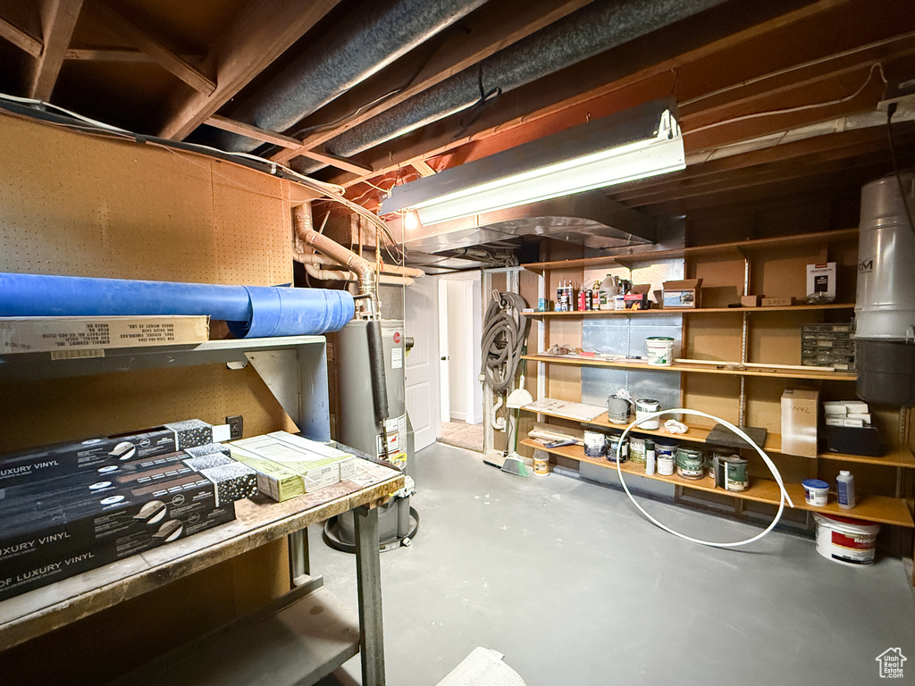 Unfinished below grade area featuring water heater