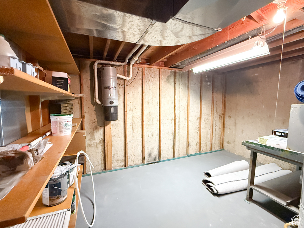 Unfinished basement with a central vacuum unit