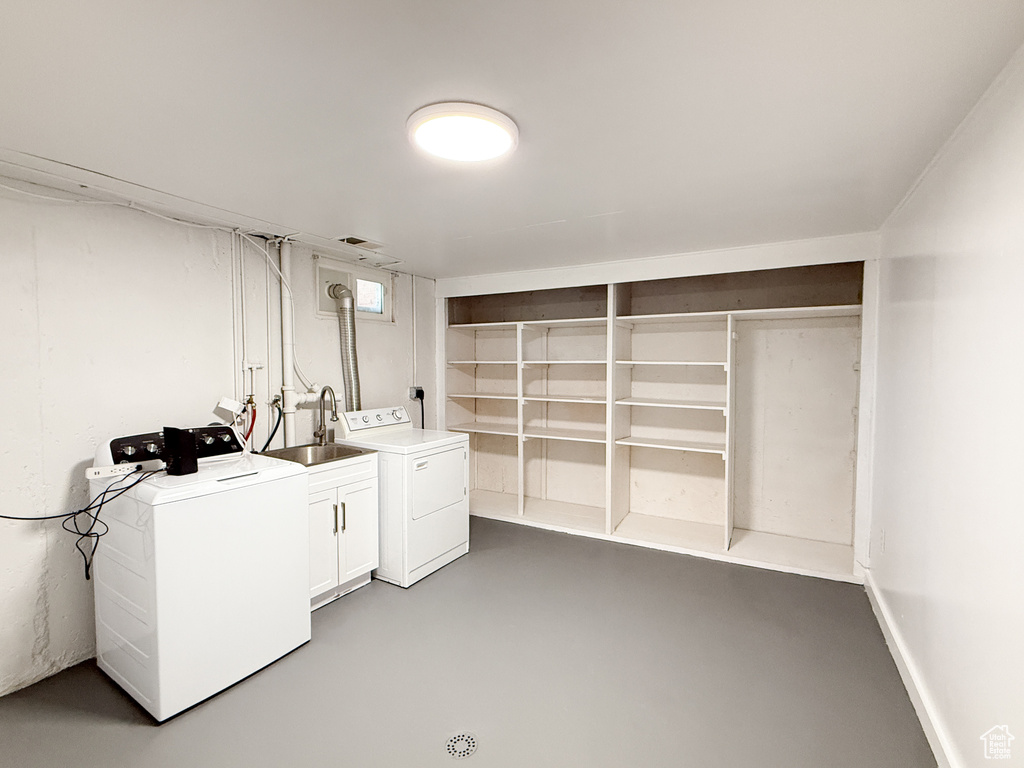 Washroom featuring washer and clothes dryer and cabinet space