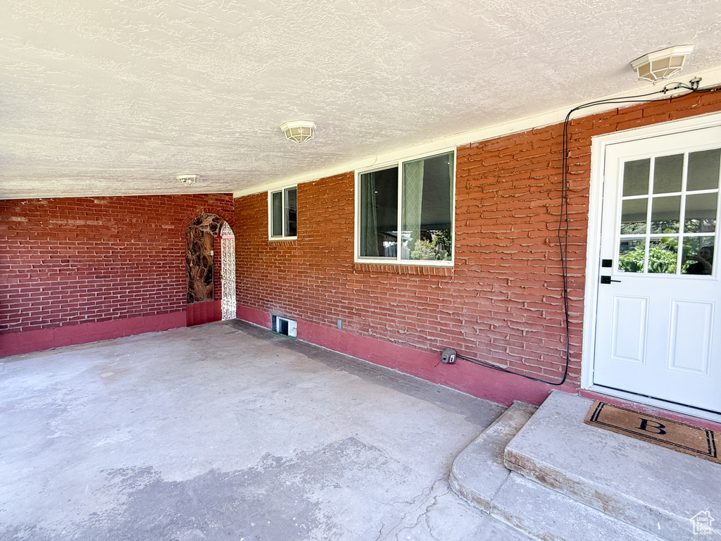 Property entrance featuring brick siding