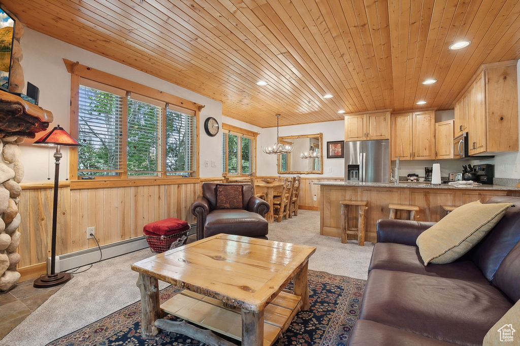 Living room featuring recessed lighting, a baseboard heating unit, a wainscoted wall, wood ceiling, and a chandelier