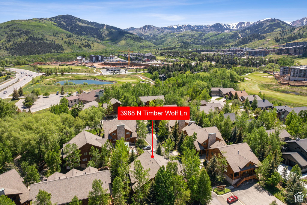Aerial view of residential area featuring a water and mountain view and a golf course