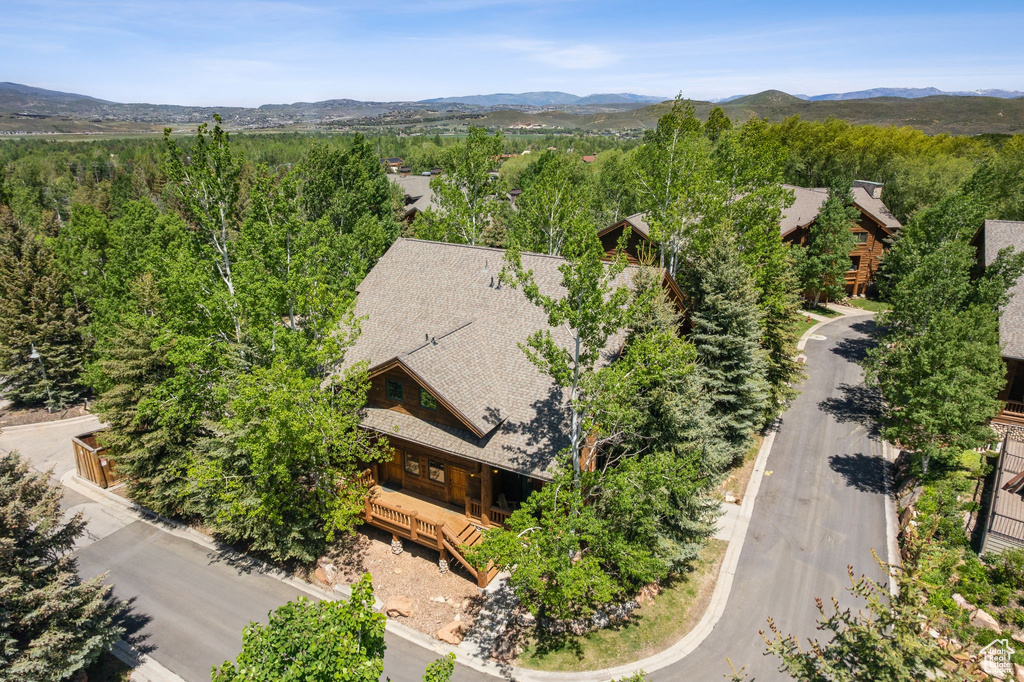 View from above of property with a mountainous background and a forest