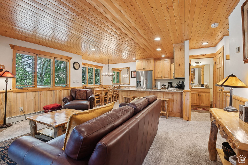 Living area with wooden ceiling, a baseboard heating unit, light carpet, recessed lighting, and wainscoting