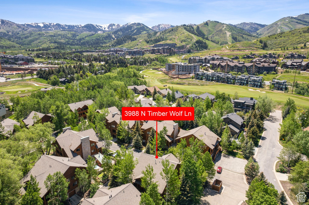 Aerial view of residential area featuring mountains and a local golf course