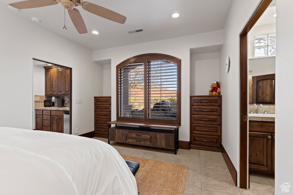 Bedroom with light tile patterned flooring, ensuite bathroom, baseboards, recessed lighting, and a sink