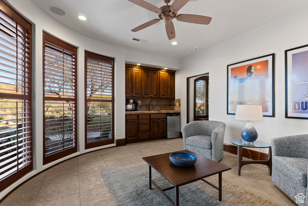 Living room featuring light tile patterned floors, ceiling fan, recessed lighting, and baseboards