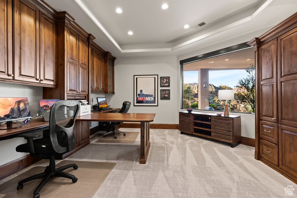 Office featuring baseboards, recessed lighting, a tray ceiling, and light colored carpet