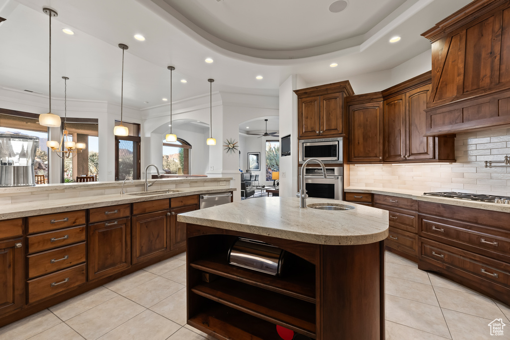 Kitchen featuring a sink, open shelves, light tile patterned floors, tasteful backsplash, and recessed lighting