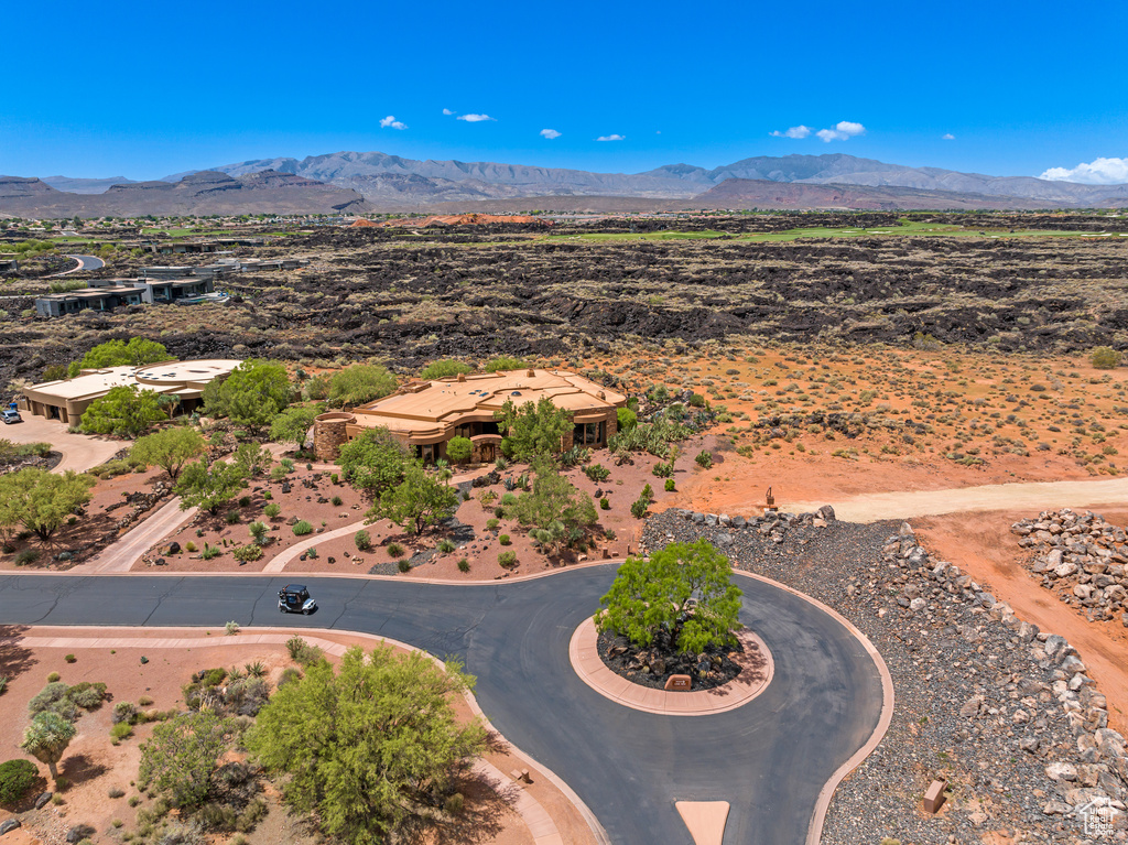 Drone / aerial view of a mountain backdrop and a desert landscape