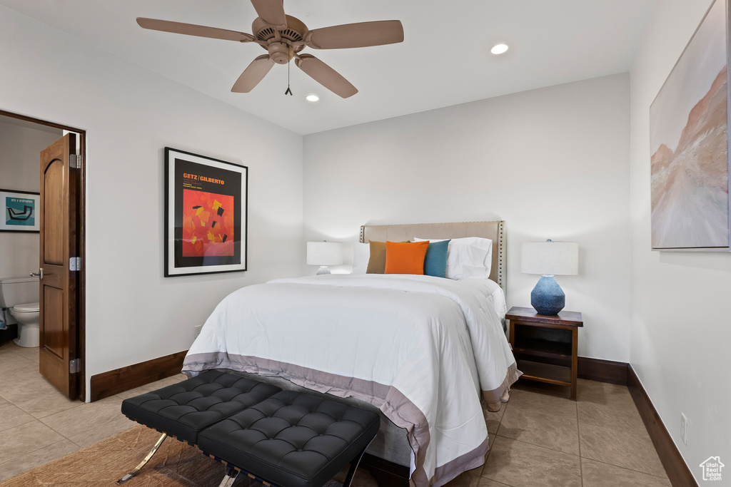 Bedroom featuring light tile patterned flooring, baseboards, recessed lighting, ensuite bath, and a ceiling fan