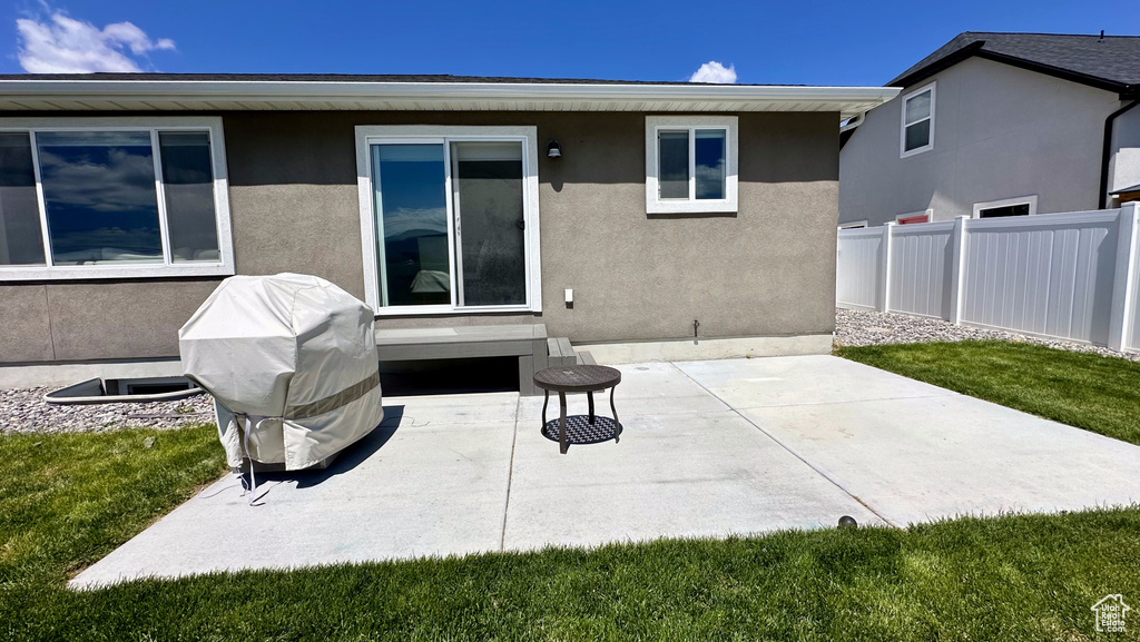 Rear view of house featuring a patio and stucco siding