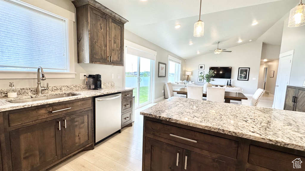 Kitchen with dishwasher, a sink, dark brown cabinets, light wood-type flooring, and ceiling fan